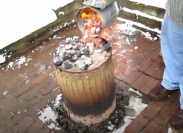 pouring hot charcoal on top of garbage can
