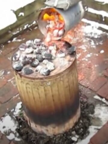 pouring hot charcoal on top of garbage can