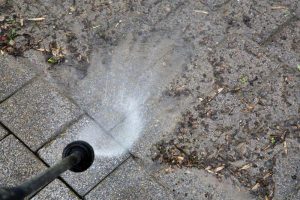 hosing surface dirt off a brick patio