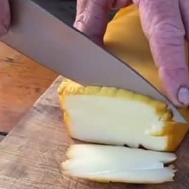 slicing smoked gouda cheese