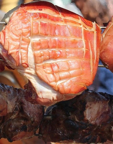 a raw ham being smoked a long time