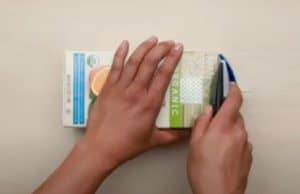 cutting the top of an orange juice carton