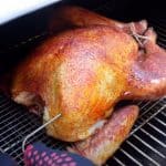 a smoked turkey cooking on a pellet grill