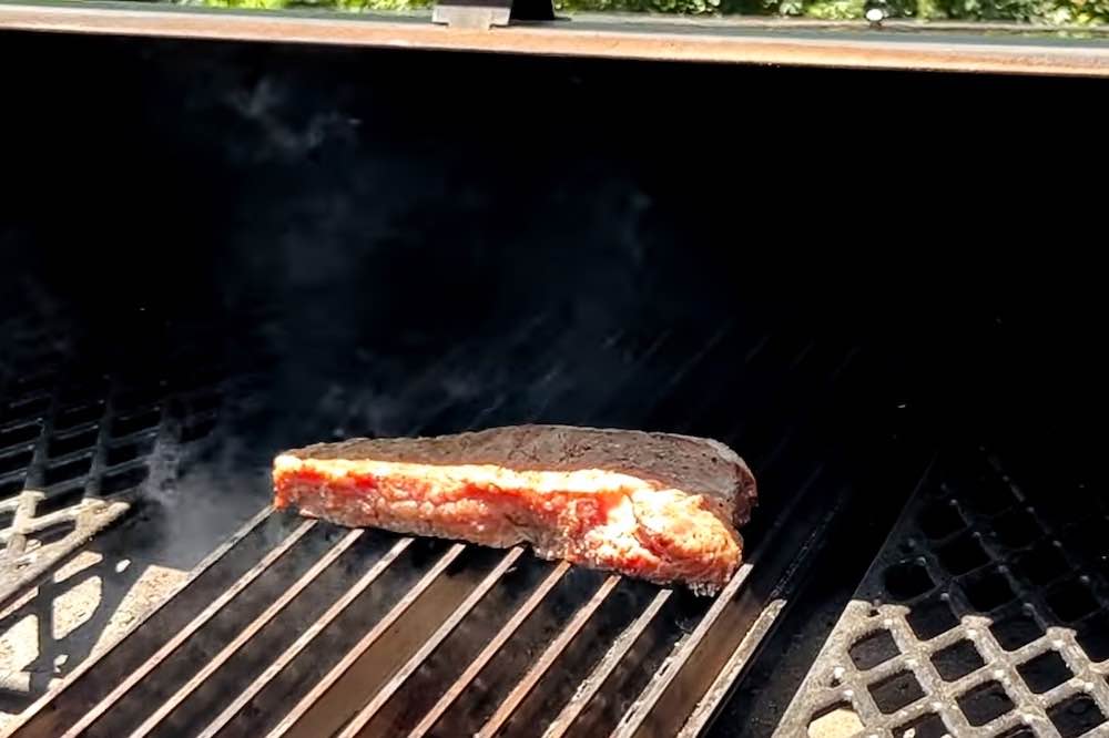 steak on grate side of grill grates on pellet grill