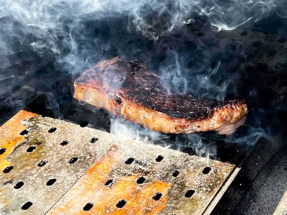 Steak searing on grill grates on pit boss pellet grill