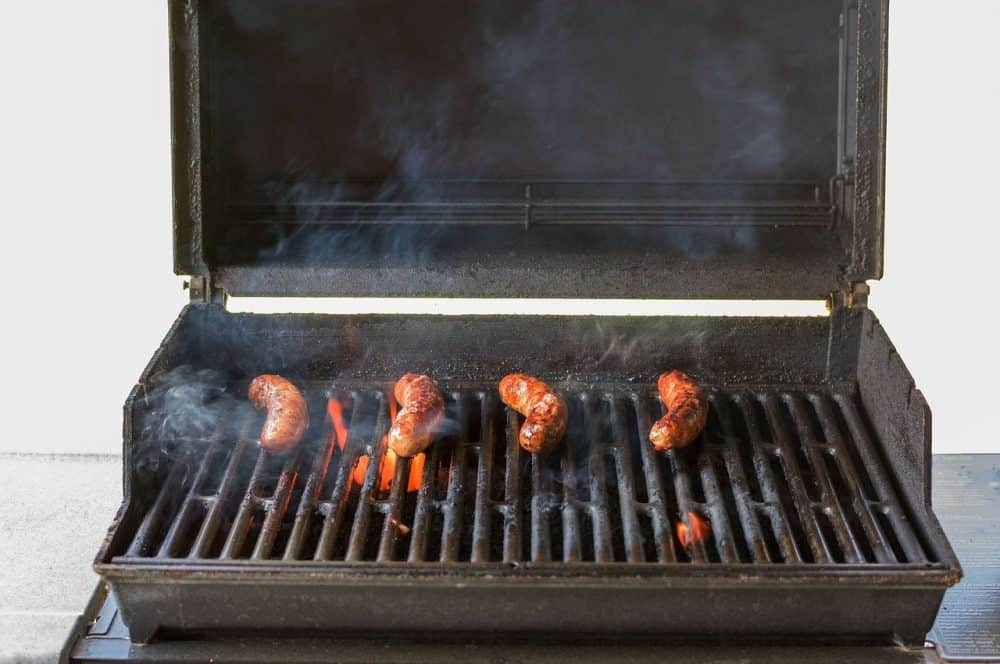 a propane grill setup for cooking brats