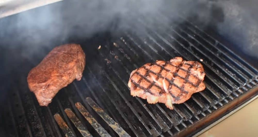 flipping steaks on a pellet grill