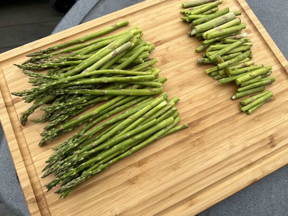 broken asparagus on cutting board before smoking