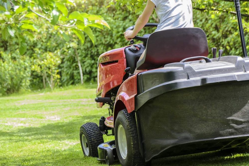 riding a fast lawmn mower on a lawn