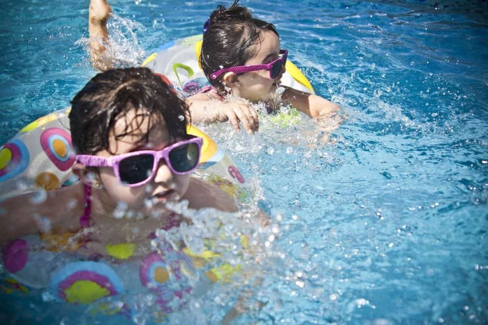 kids swimming in a pool with safe chlorine levels