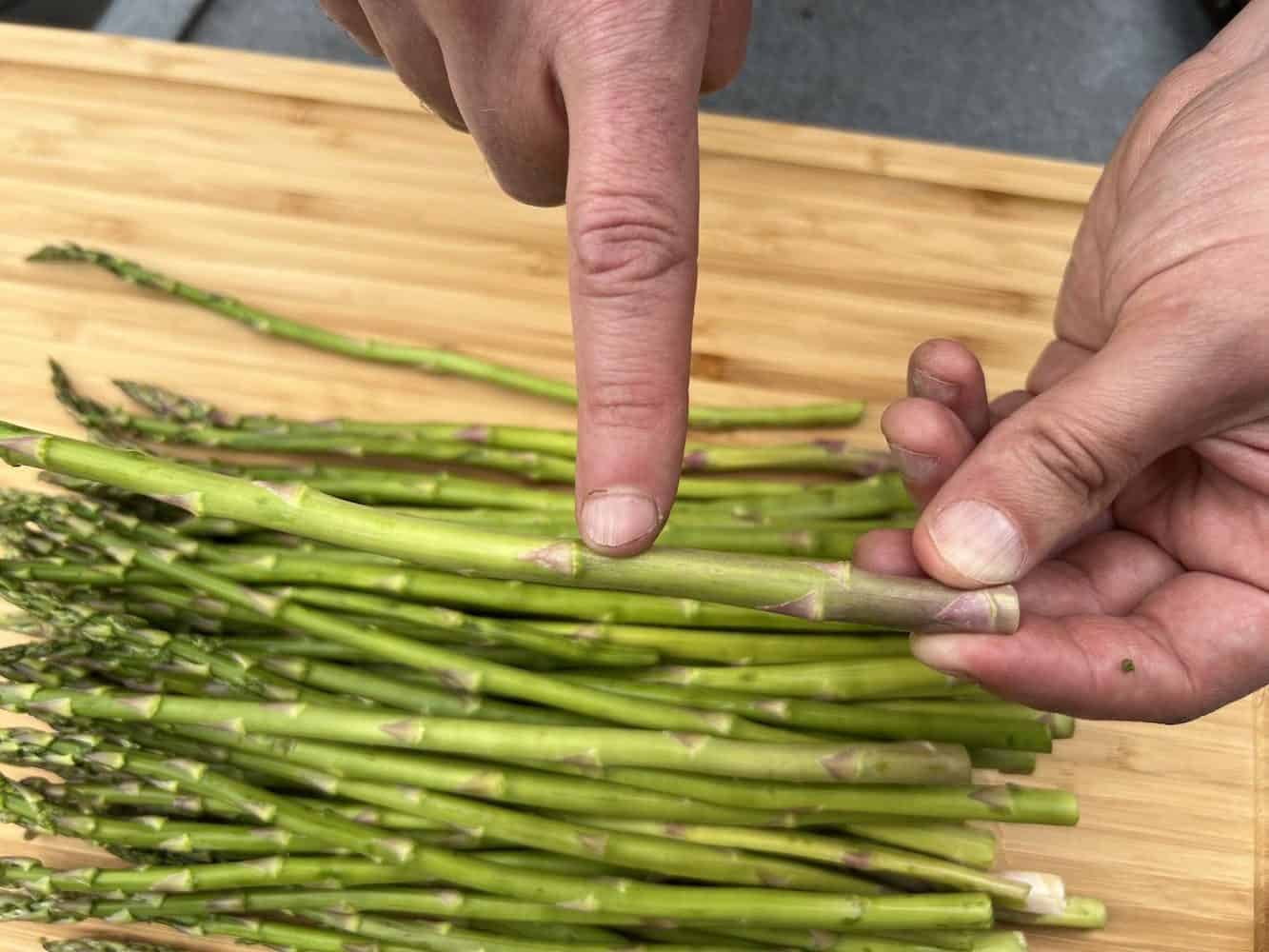 pointing where to break asparagus before smoking