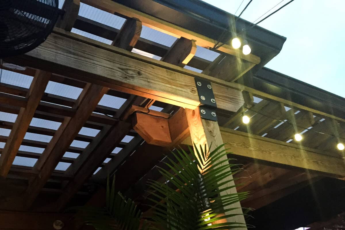 string lights attached to a wooden pergola