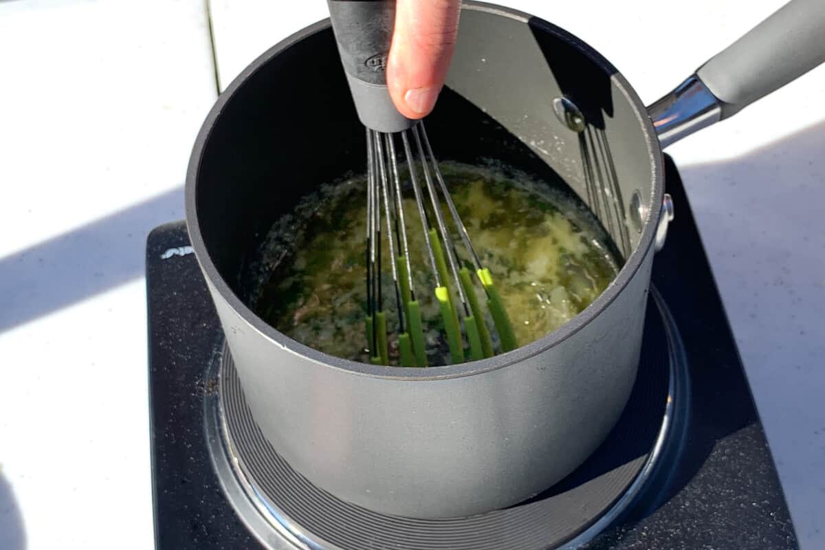 whisking lemon garlic butter in a saucepan