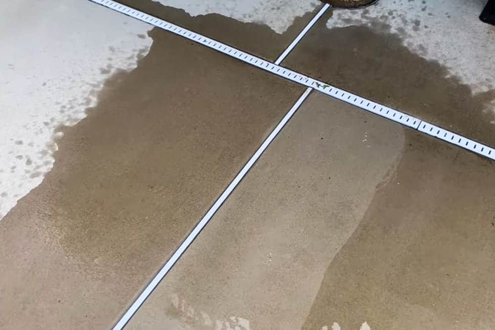 Pool deck before and after cleaning with Sun Joe brush attachment 