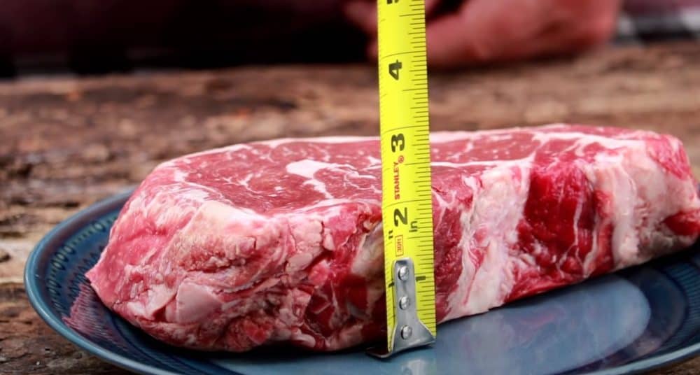 measuring a raw ribeye steak before smoking