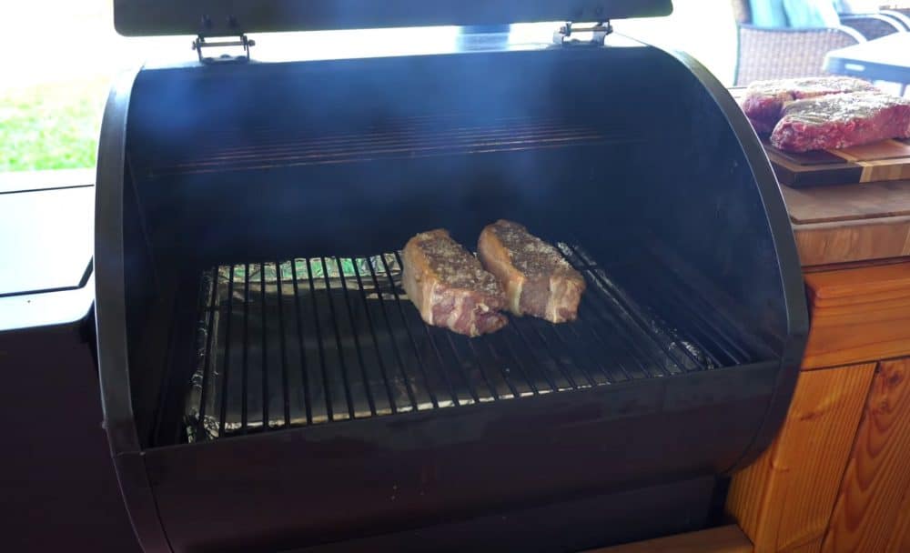 ribeye steaks on a smoker
