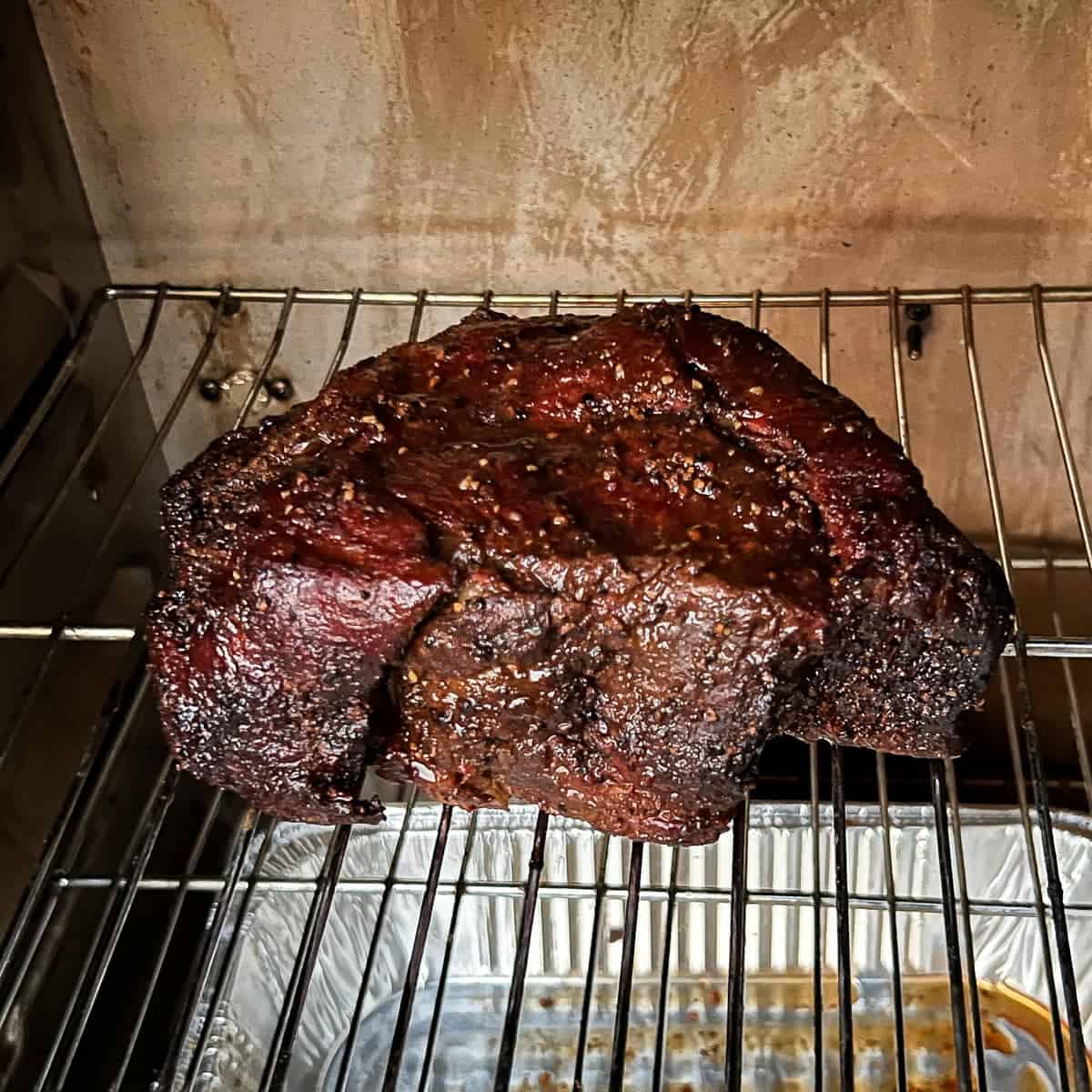 Chuck roast smoking in a Masterbuilt electric smoker