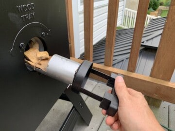 loading wood chips into a masterbuilt electric smoker