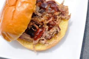 a smoked pulled pork sandwich on a bun