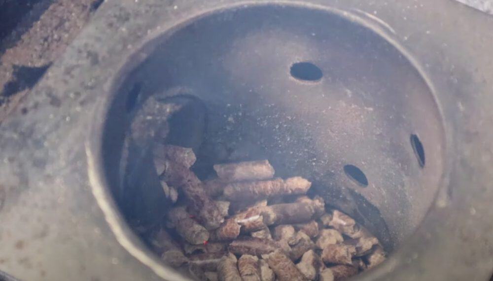 the firepot of a pellet grill burning pellets