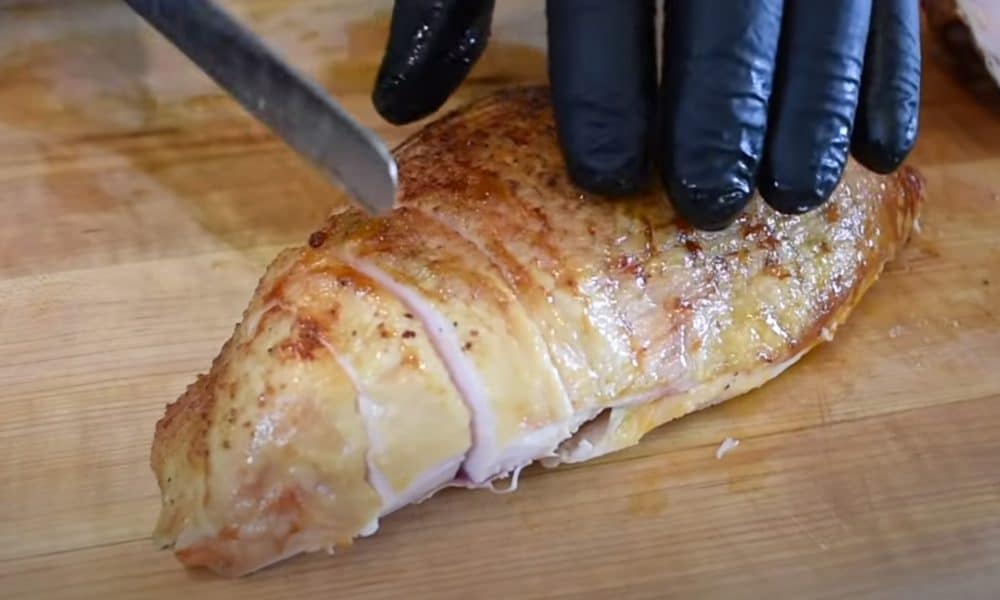 carving a smoked turkey breast cooked on a pellet grill