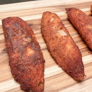 Honey Smoked Tilapia with Cajun Seasoning on a wooden cutting board