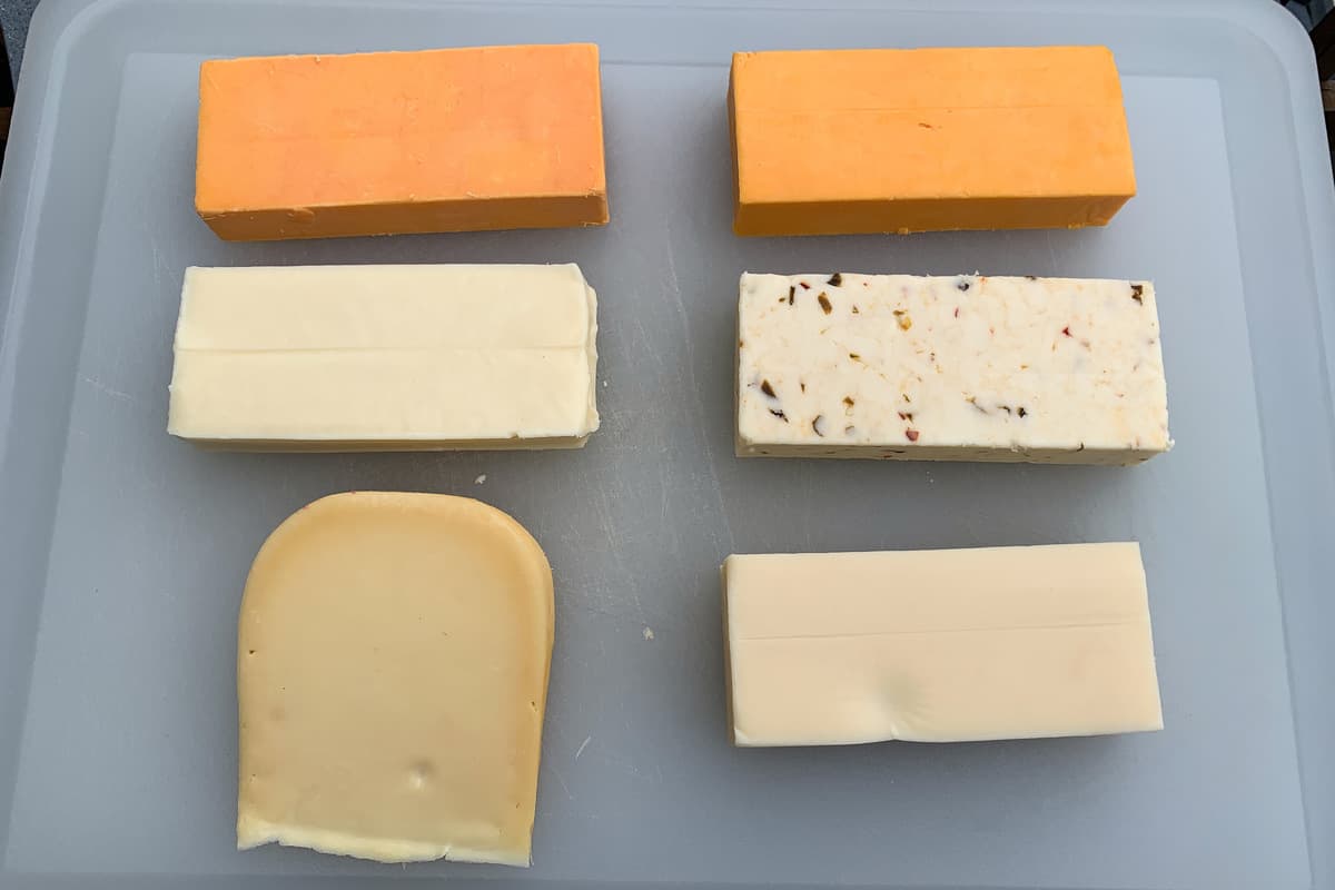 blocks of cheese on a cutting board