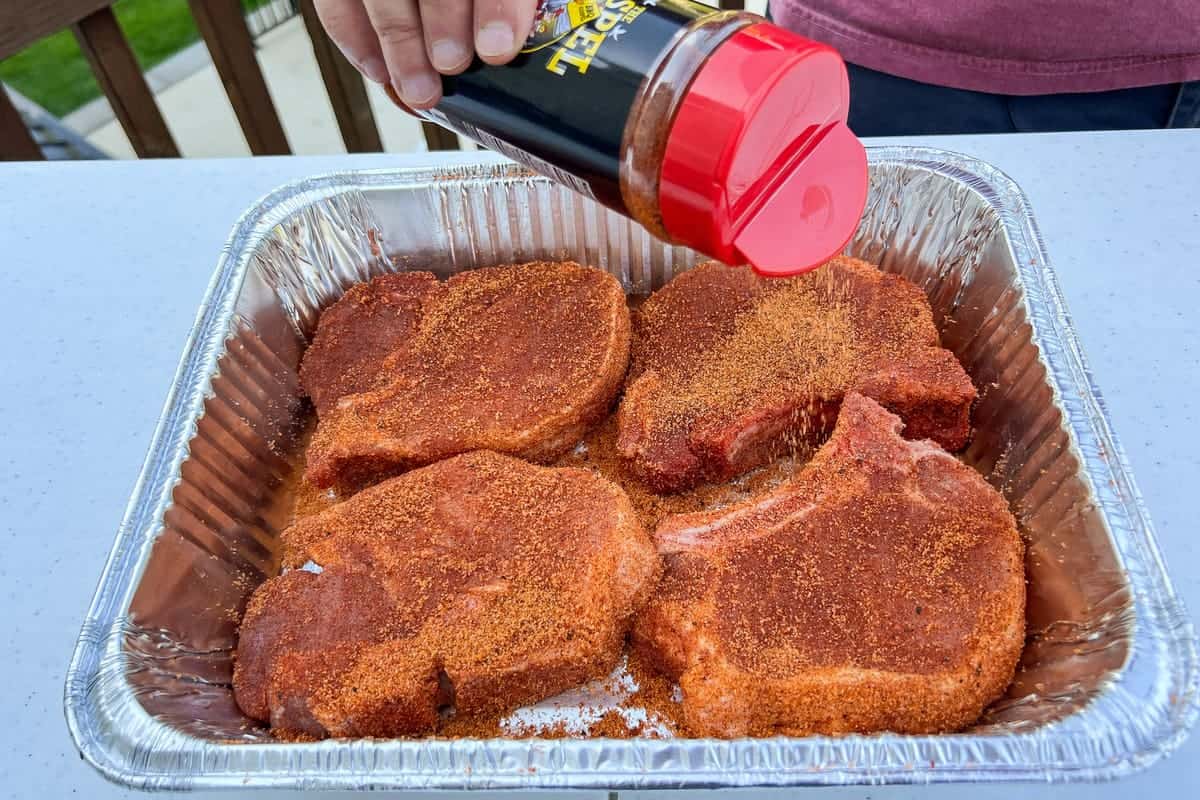 sprinkling Meat Church The Gospel on thick cut pork chops