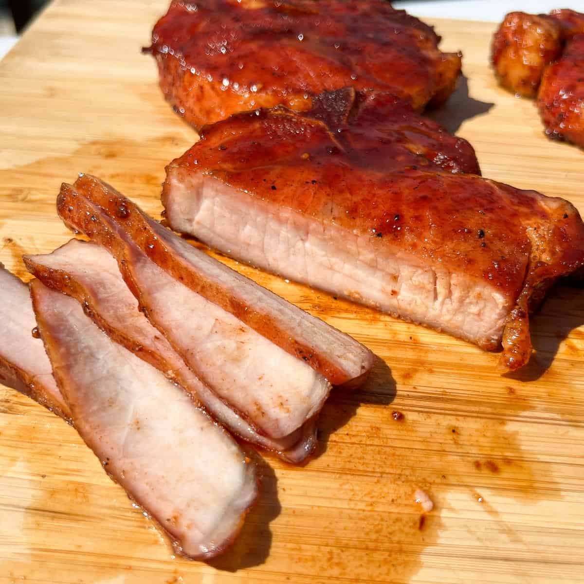 thin slices of pork chops on a cutting board