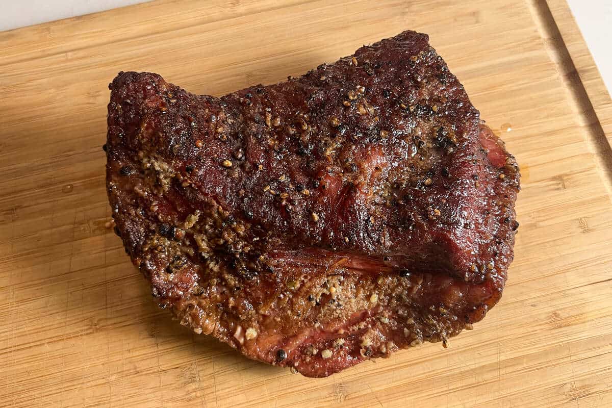 corned beef brisket resting on a wooden cutting board