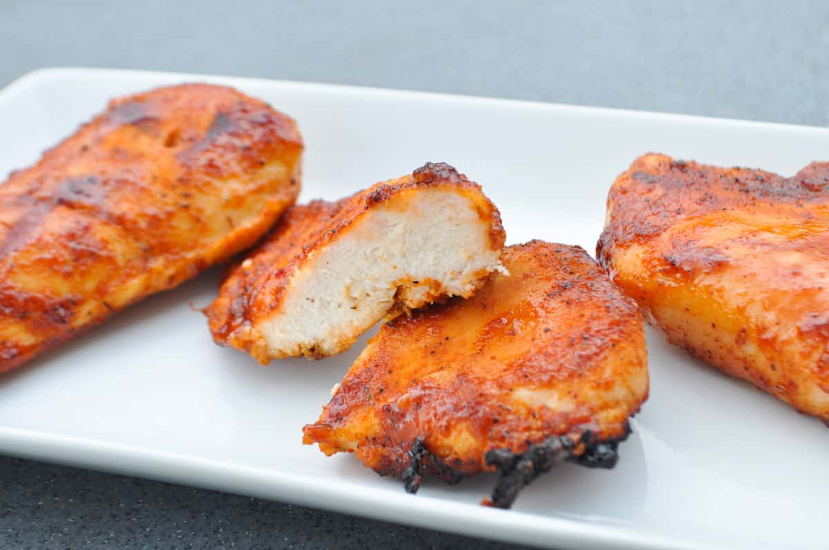 Pit Boss chicken breast cut in half to show inside on a white plate