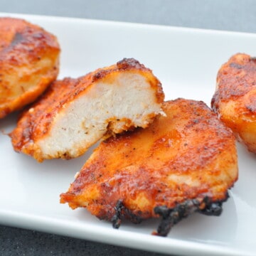 Pit Boss chicken breast cut in half to show inside on a white plate