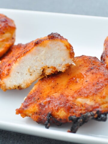 Pit Boss chicken breast cut in half to show inside on a white plate