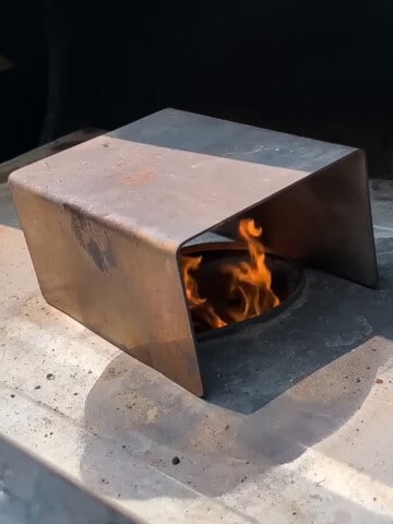 Flame tamer on fire pot of a pit boss pellet grill