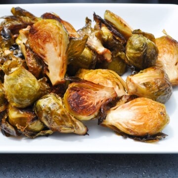 Smoked Brussel sprouts on a white plate