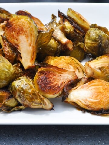 Smoked Brussel sprouts on a white plate