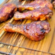 electric smoker smoked chicken legs on a cutting board