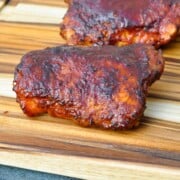 electric smoker chicken thighs on a cutting board
