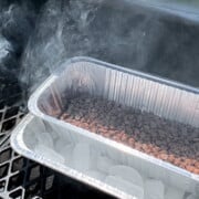 Smoked Chocolate Chips in a foil pan on ice in a pellet grill