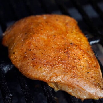 smoked tuna steak on the grates of a grill