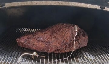 a brisket cooking on a pellet grill