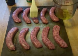 brushing oil on brats before cooking