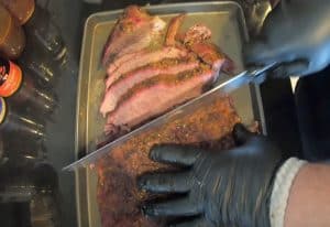 slicing a hot and fast brisket after taking off the pellet grill