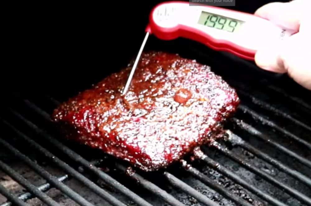 checking temperature of smoked corned beef