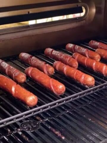 smoked hot dogs on a smoker