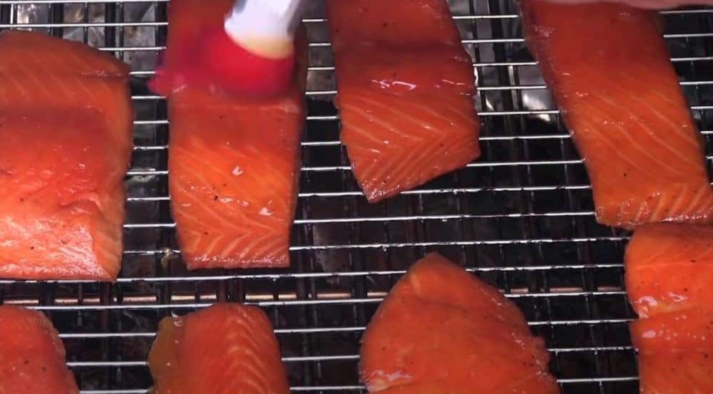 spreading honey on smoked salmon
