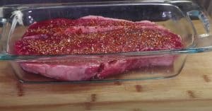 putting seasoning rub on london broil before smoking