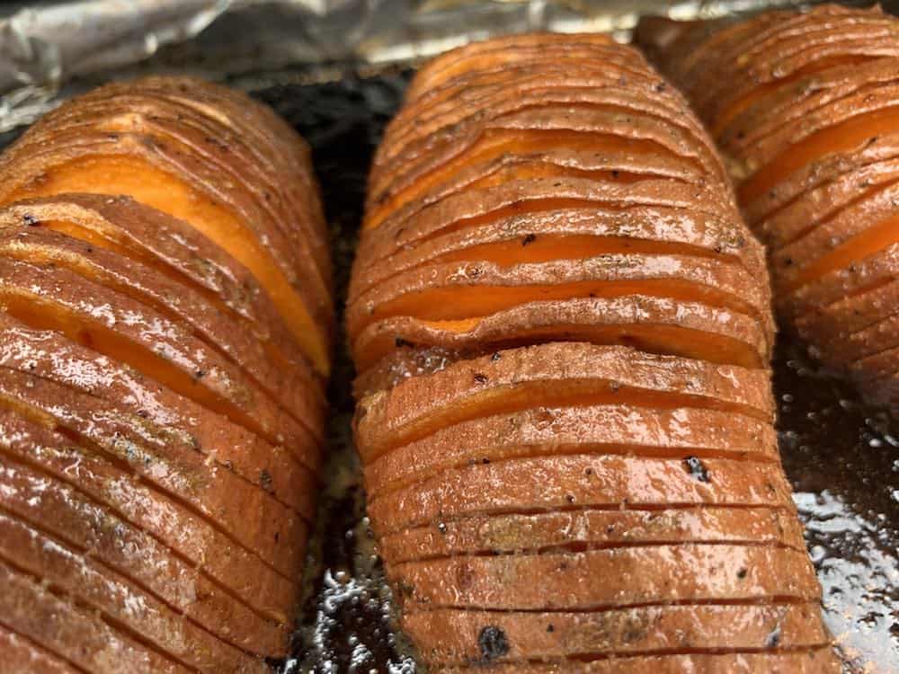 sweet potatoes smoking in a smoker