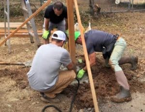 setting the posts for a backyard DIY batting cage