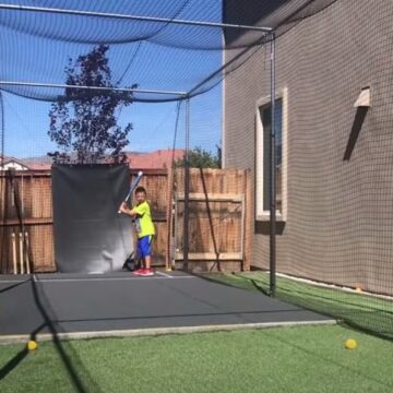 kids playing in a homemade batting cage